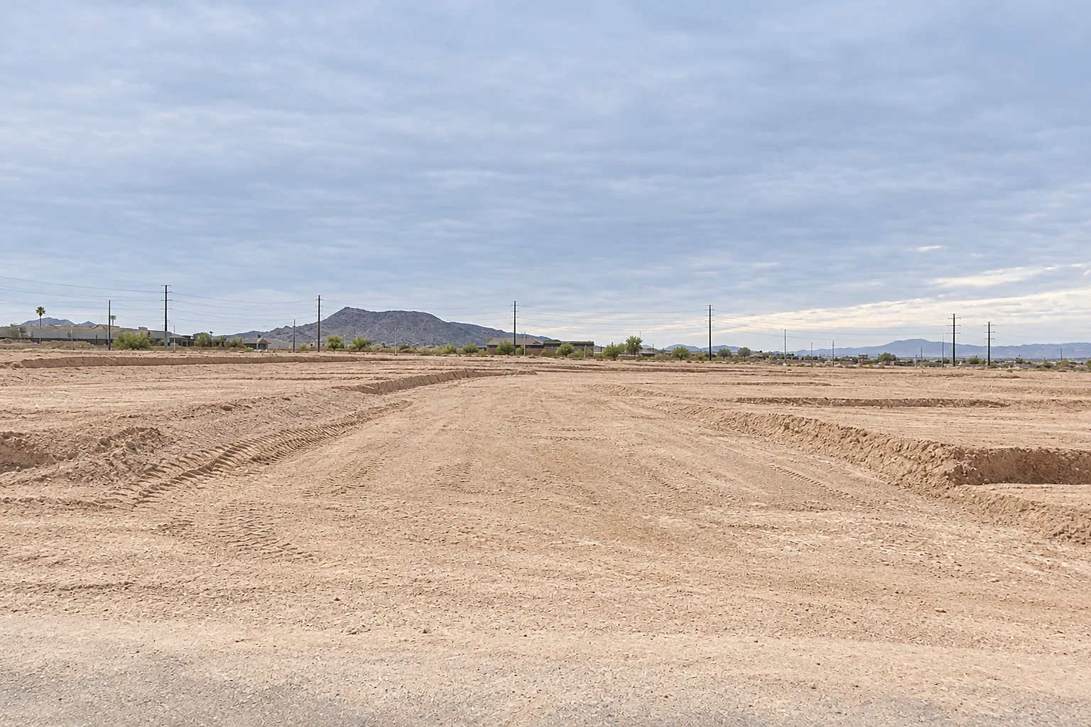 Freshly graded desert land in Henderson, Nevada, with low mountains on the horizon