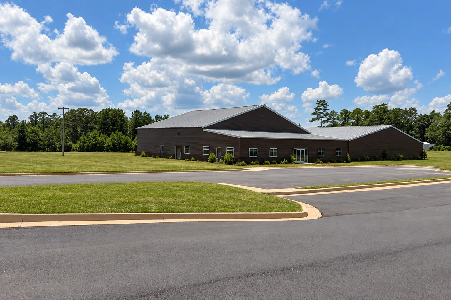 Existing metal buildings and parking lot at the Woodland, Alabama property